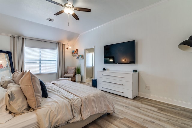 bedroom with ceiling fan, vaulted ceiling, and light wood-type flooring