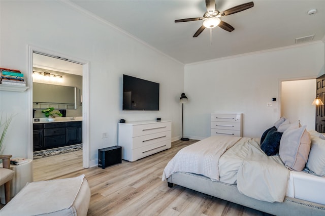 bedroom with crown molding, ensuite bathroom, ceiling fan, and light hardwood / wood-style flooring