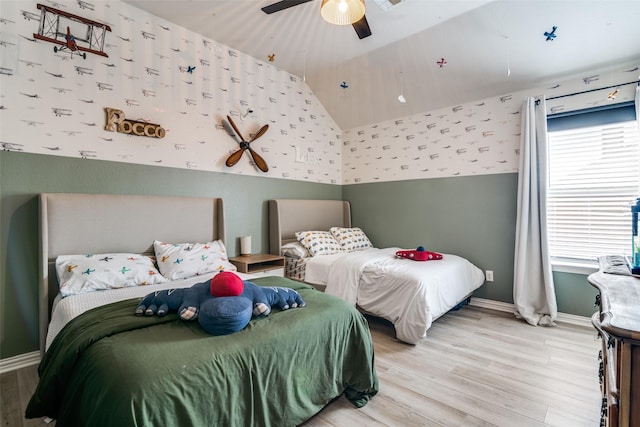 bedroom with hardwood / wood-style flooring, ceiling fan, and vaulted ceiling