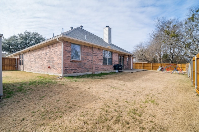 back of property featuring a yard and a patio area