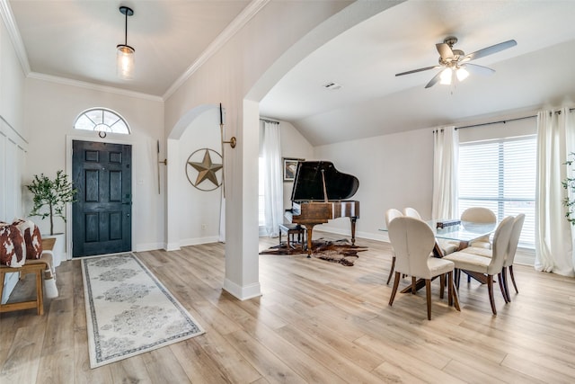 entrance foyer featuring crown molding, plenty of natural light, and light hardwood / wood-style floors