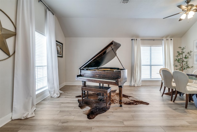 interior space with vaulted ceiling, ceiling fan, and light hardwood / wood-style floors