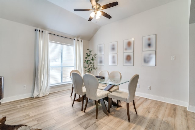 dining space with vaulted ceiling, ceiling fan, and light hardwood / wood-style flooring