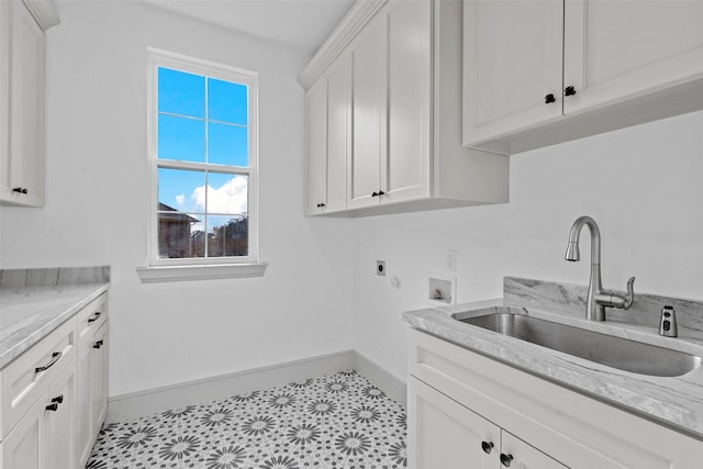 washroom featuring hookup for a washing machine, cabinet space, hookup for an electric dryer, a sink, and baseboards