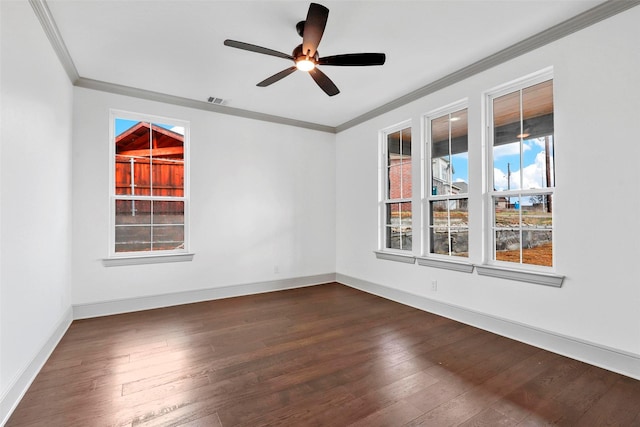 unfurnished room with ornamental molding, dark wood-style flooring, visible vents, and baseboards