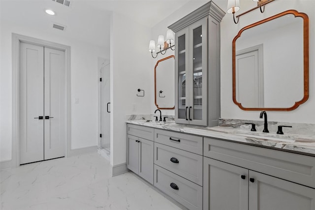 bathroom with marble finish floor, a sink, baseboards, and double vanity