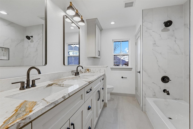 full bath featuring toilet, baseboards, visible vents, and a sink