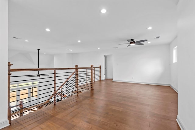 spare room with a ceiling fan, wood finished floors, visible vents, and recessed lighting