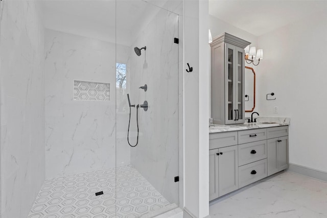 full bathroom with marble finish floor, a marble finish shower, baseboards, and vanity