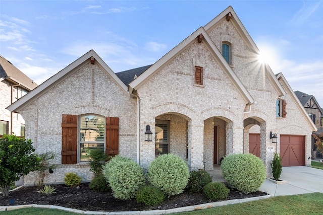 french country inspired facade featuring a garage