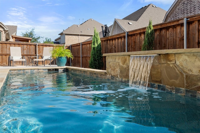 view of pool with pool water feature