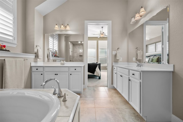 bathroom featuring tile patterned flooring, vanity, a bath, and ceiling fan