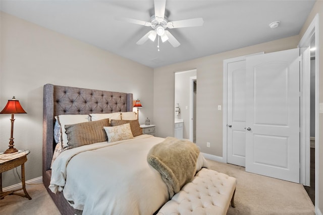 carpeted bedroom featuring ceiling fan and ensuite bathroom