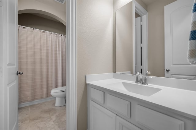 bathroom with vanity, tile patterned floors, and toilet