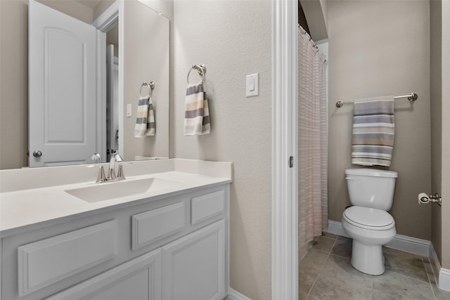 bathroom with tile patterned floors, vanity, and toilet