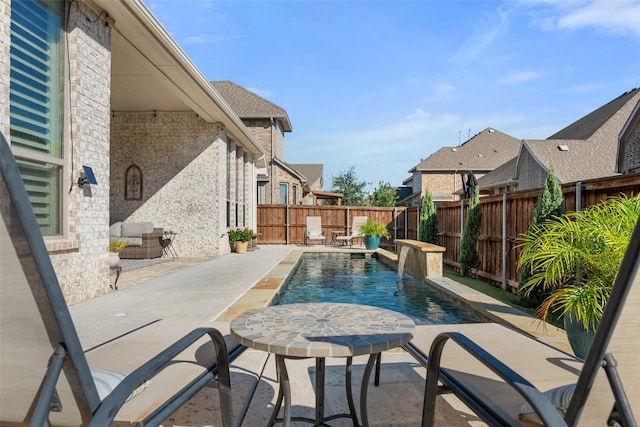 view of pool with pool water feature and a patio area