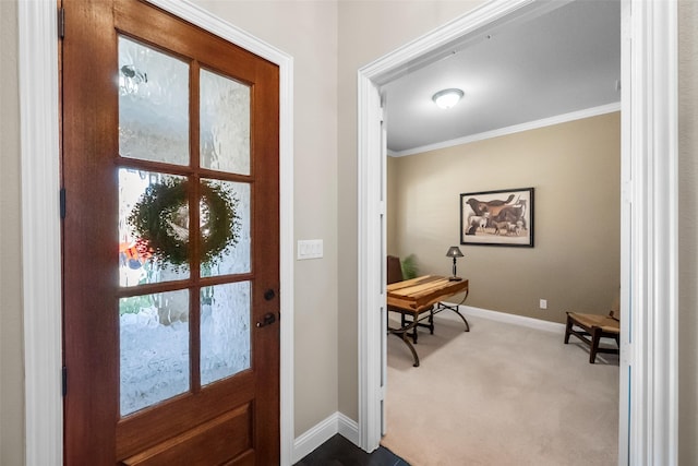 foyer entrance with crown molding and carpet floors