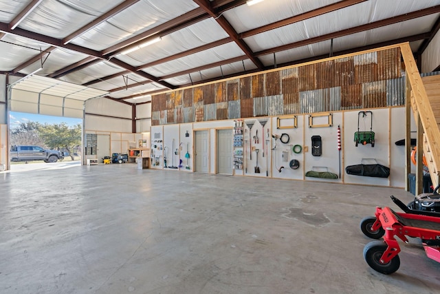 kitchen with light stone counters, a towering ceiling, and a barn door