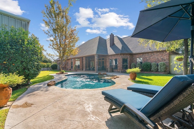 view of pool featuring a patio and a yard