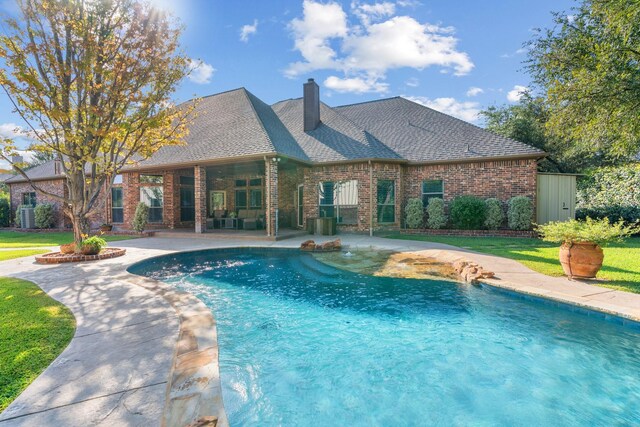 view of pool featuring a yard and a patio