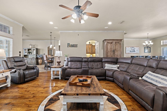 living room with crown molding, ceiling fan with notable chandelier, and hardwood / wood-style floors