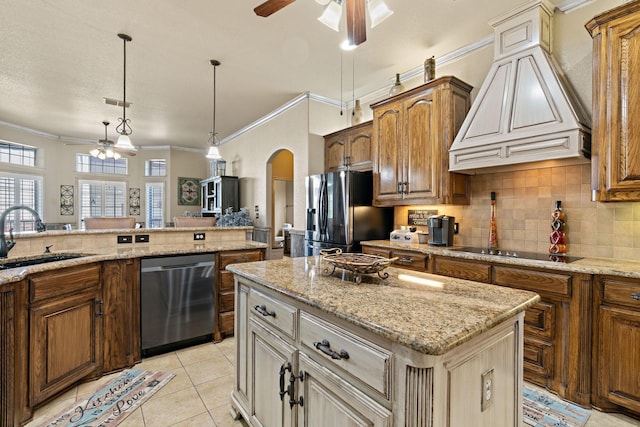 kitchen with a kitchen island, decorative light fixtures, sink, stainless steel appliances, and custom range hood