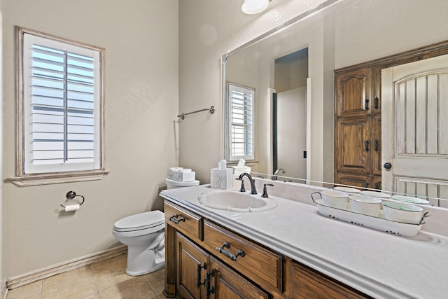 bathroom featuring vanity, tile patterned floors, and toilet