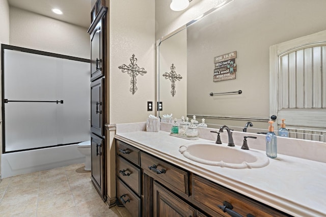 full bathroom featuring toilet, vanity, shower / bath combination with glass door, and tile patterned flooring