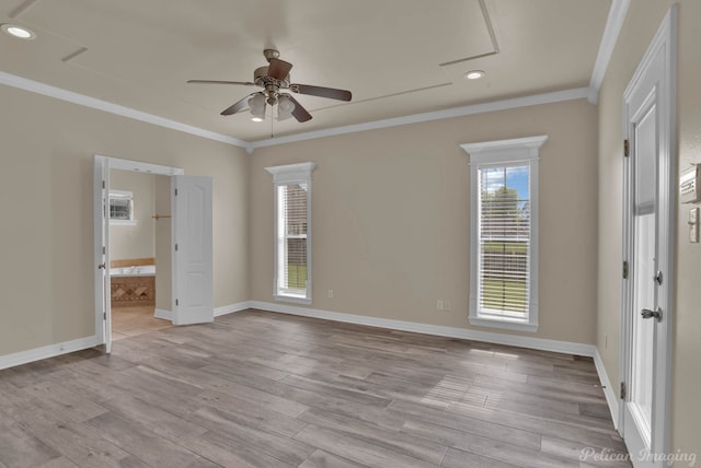 empty room with ceiling fan, ornamental molding, and light hardwood / wood-style flooring