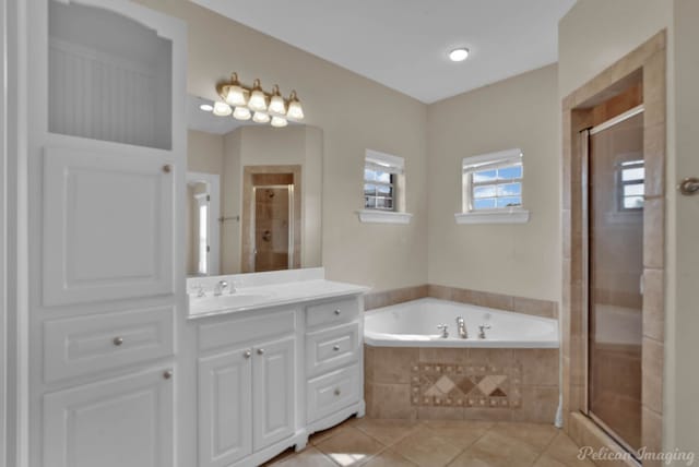 bathroom with tile patterned floors, independent shower and bath, and vanity