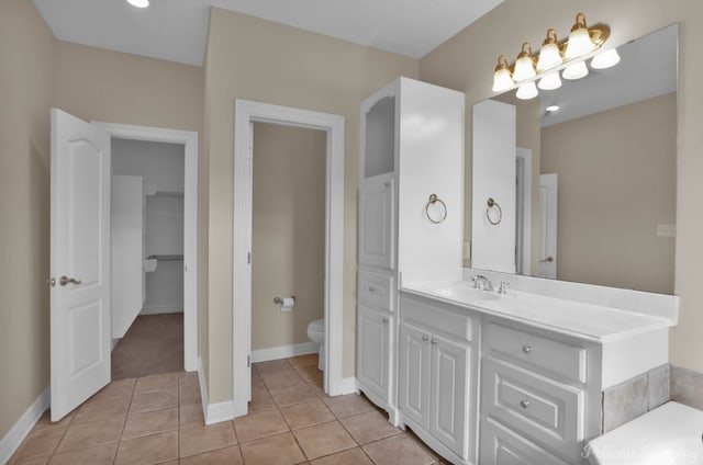 bathroom with vanity, tile patterned floors, and toilet