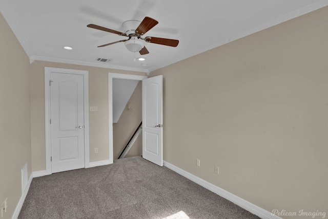 unfurnished bedroom featuring crown molding, ceiling fan, and carpet