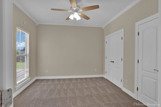 unfurnished room featuring crown molding, light colored carpet, and ceiling fan