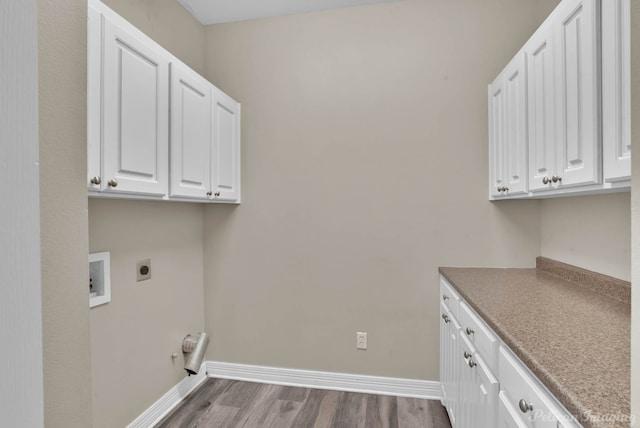 laundry area featuring hardwood / wood-style flooring, cabinets, hookup for a washing machine, and electric dryer hookup