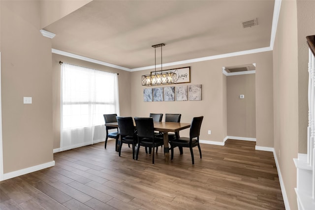 dining room with hardwood / wood-style floors and ornamental molding