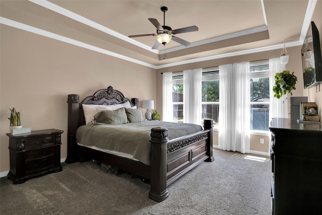 bedroom with carpet floors, ornamental molding, a raised ceiling, and ceiling fan