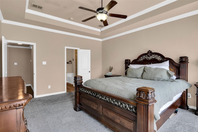 bedroom with ornamental molding, carpet floors, ceiling fan, and a tray ceiling