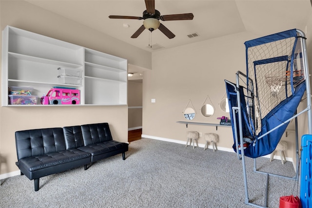 living area with ceiling fan and carpet