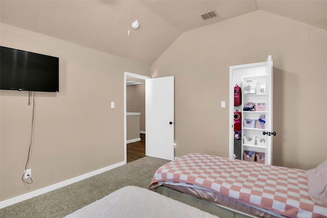 carpeted bedroom featuring vaulted ceiling