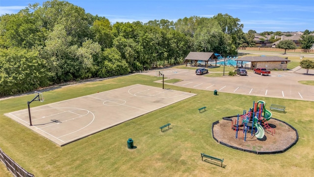 view of sport court featuring a yard and a playground