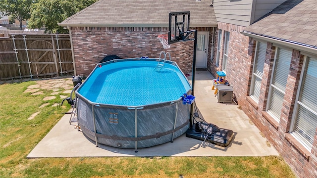 view of pool with a lawn