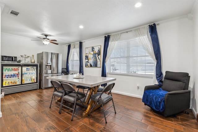 dining room with crown molding, dark wood-type flooring, and ceiling fan