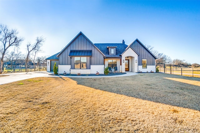 modern inspired farmhouse featuring a front lawn