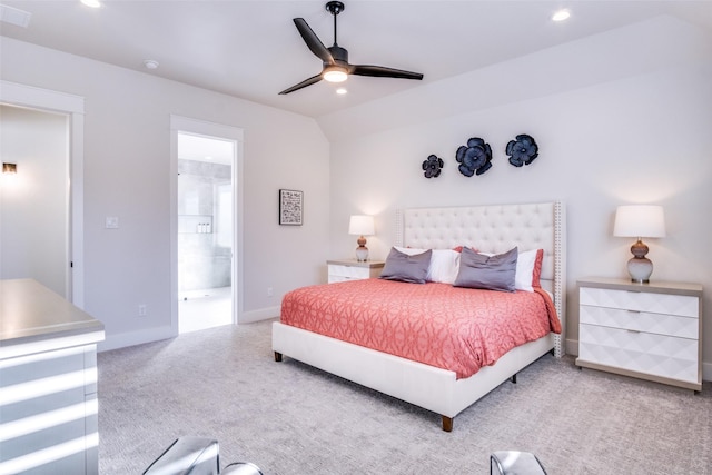 carpeted bedroom featuring lofted ceiling, ensuite bath, and ceiling fan