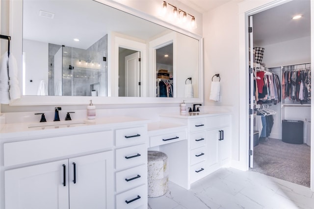 bathroom with vanity and a shower with door