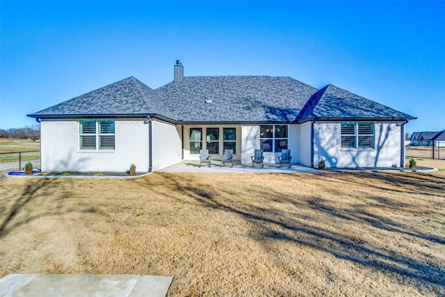 back of house featuring a yard and a patio