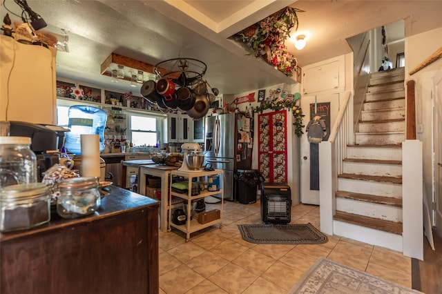 kitchen featuring stainless steel fridge and light tile patterned flooring