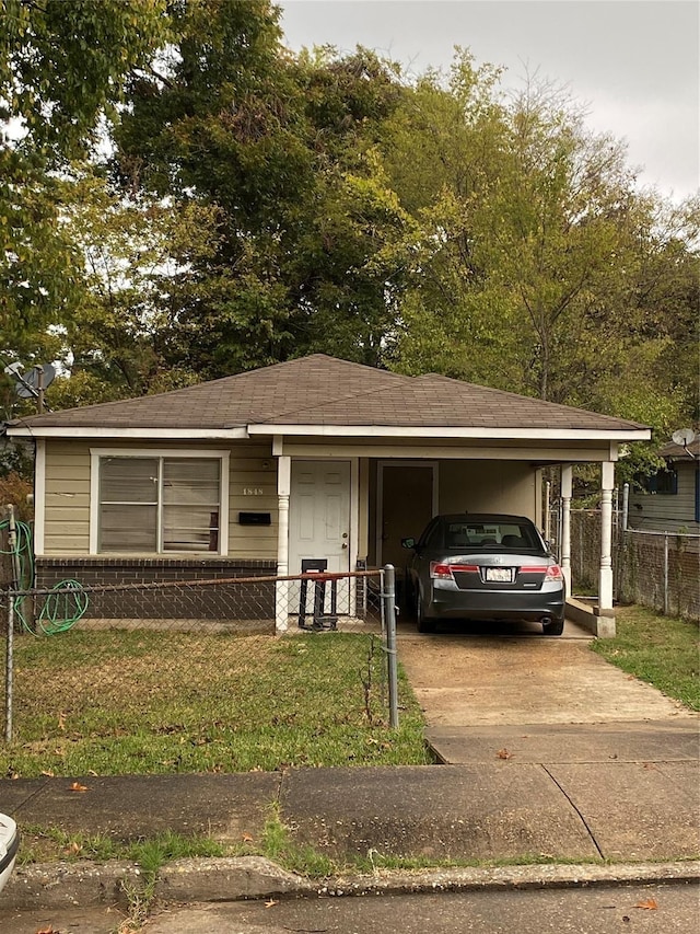 view of front facade with a carport and a front yard