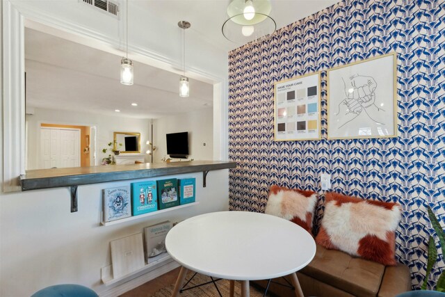 kitchen featuring pendant lighting, white cabinetry, light hardwood / wood-style floors, stainless steel fridge with ice dispenser, and decorative backsplash