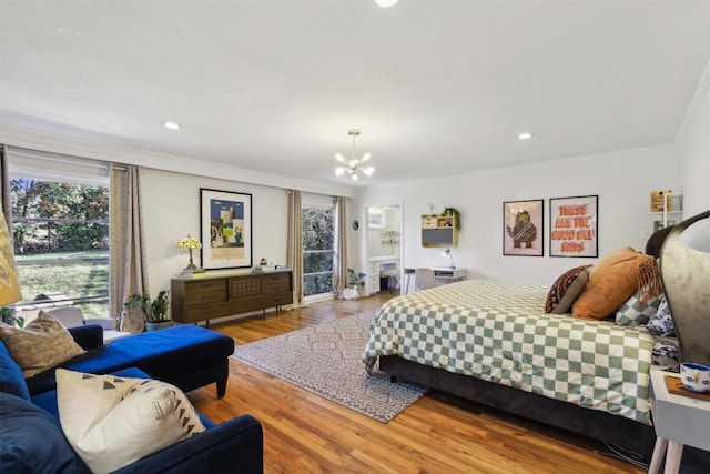 bedroom with access to outside, wood finished floors, recessed lighting, an inviting chandelier, and crown molding